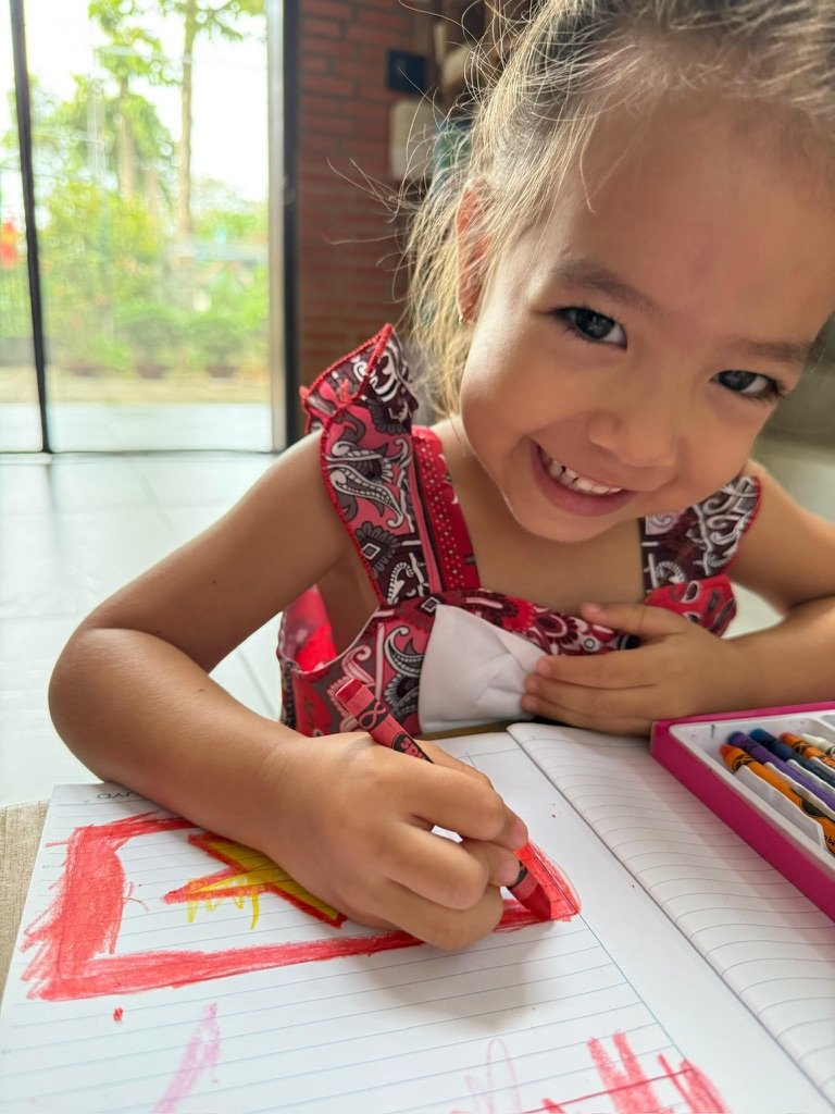 Rosie drawing with crayons